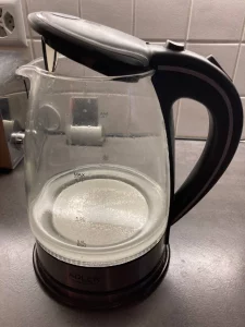 Stark verkalkter Heißwasserkessel mit sichtbaren Kalkablagerungen im Inneren.